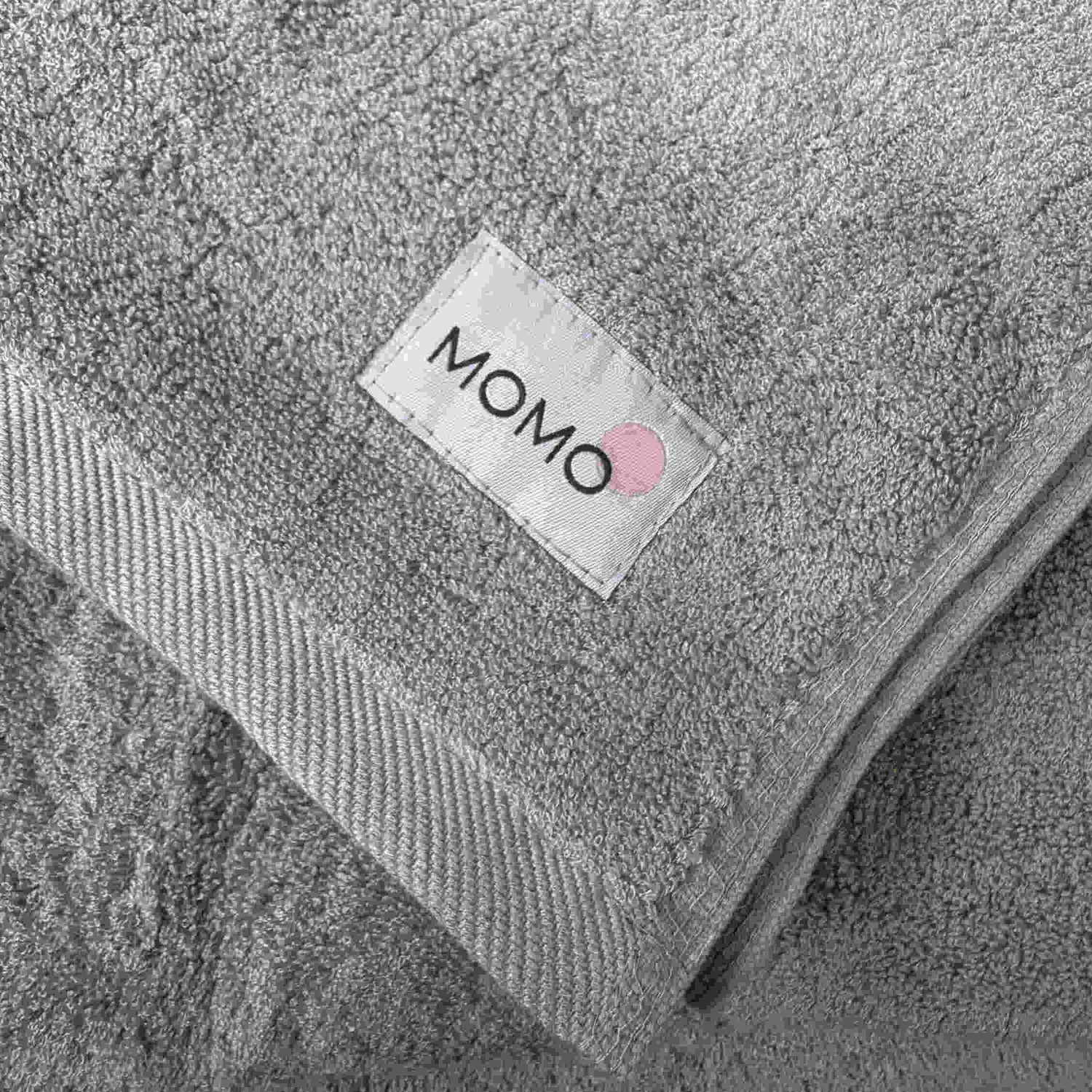 Close-up of grey bamboo towel with logo – soft, absorbent and sustainable fabric