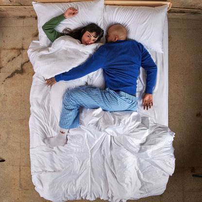 Couple in bed with white bamboo duvet cover set, overhead view