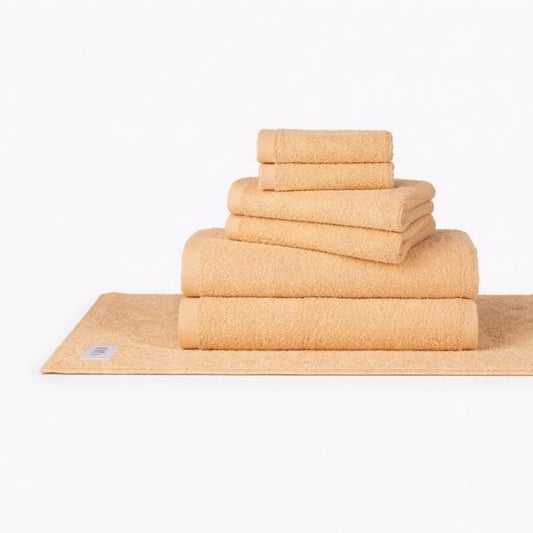Momo Cotton Wabi Sabi towel set stacked in beige, displayed on white background