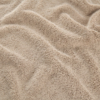 Beige bamboo towel set showing soft, textured fabric detail of face, hand and bath towels