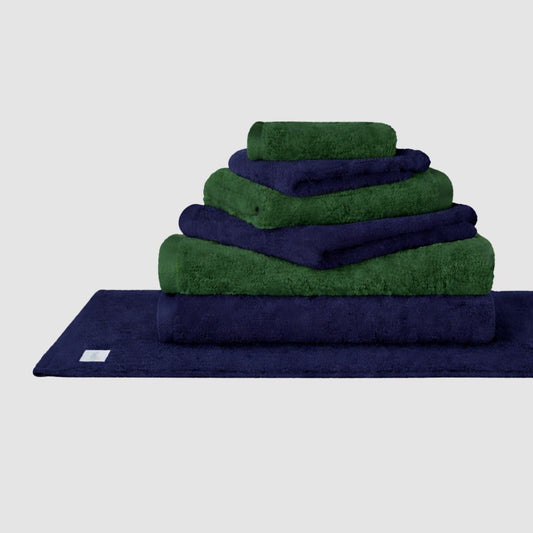 Stacked navy and green Wabi Sabi towel set by Momo Cotton displayed on neutral background