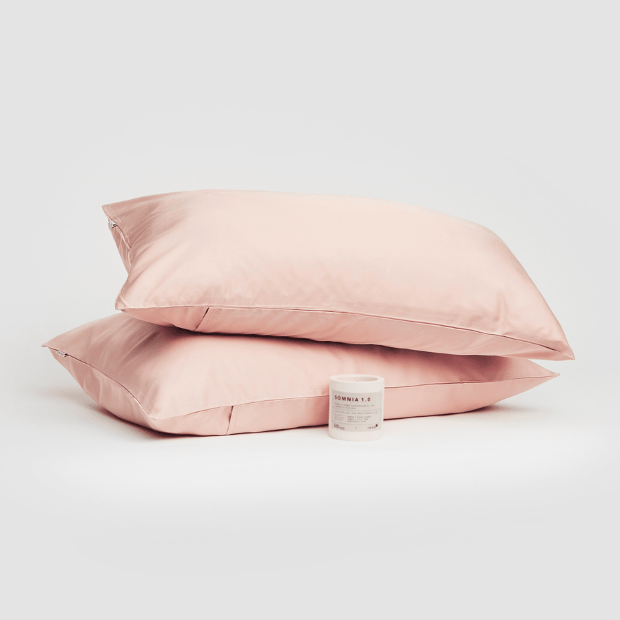 Pair of pink cotton pillowcases displayed with Somnia 1.0 product on white background