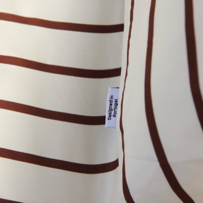 Adjustable bamboo fitted sheet with brown and white stripe pattern, side view of silky fabric