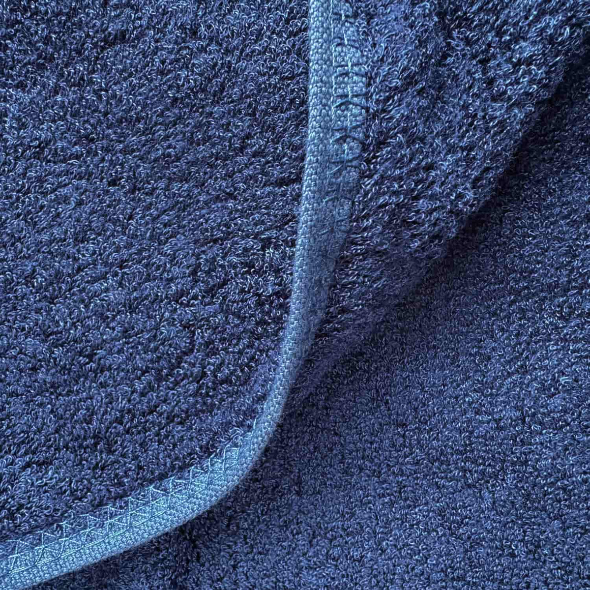 Blue wabi-sabi bath mat with textured cotton weave, folded edge detail, 50x90cm size
